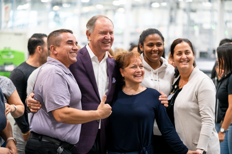 President and Founder Reinhold Schmieding takes a photo with employees during a visit to Arthrex Manufacturing Inc East.